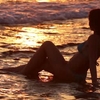 depositphotos_70718749-stock-video-sunset-woman-sits-on-wet-1.jpg